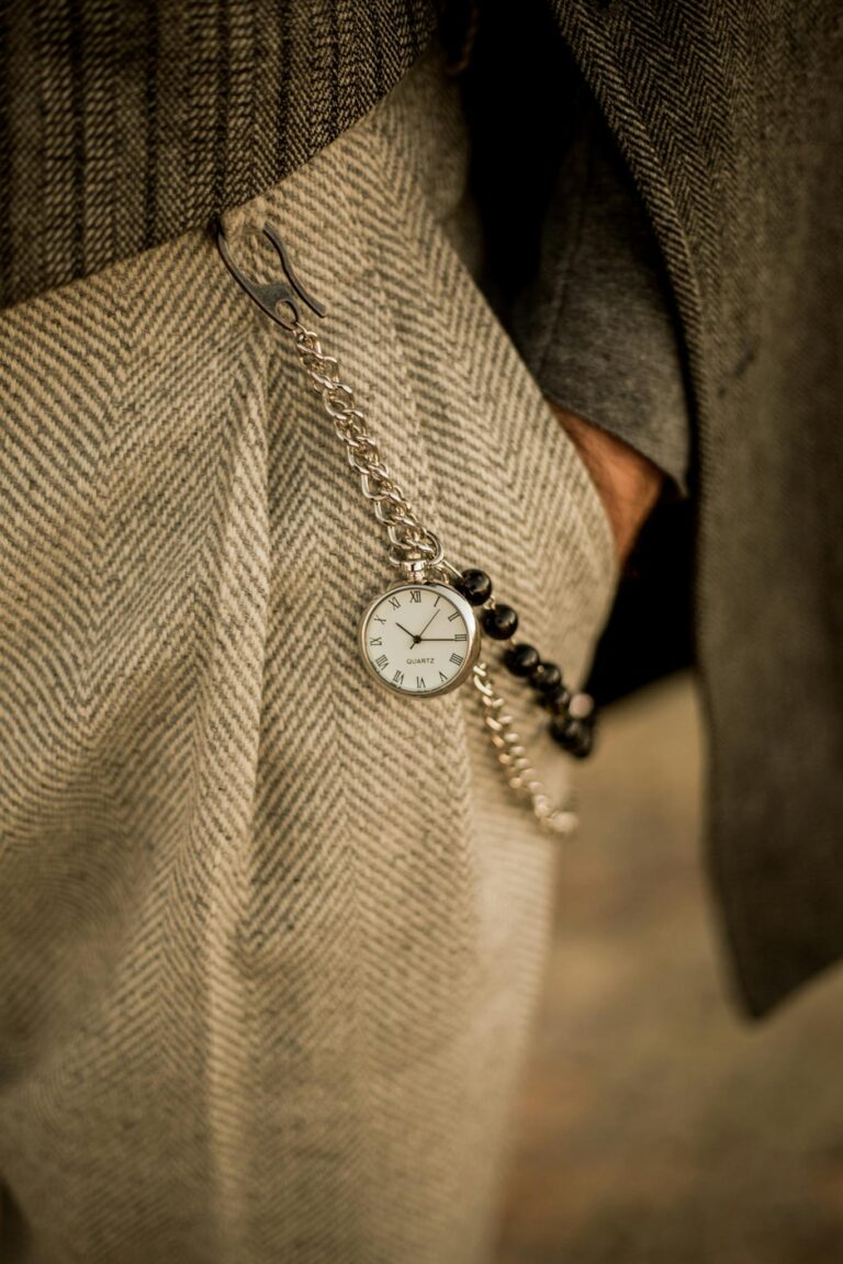 A man wearing a watch and a chain