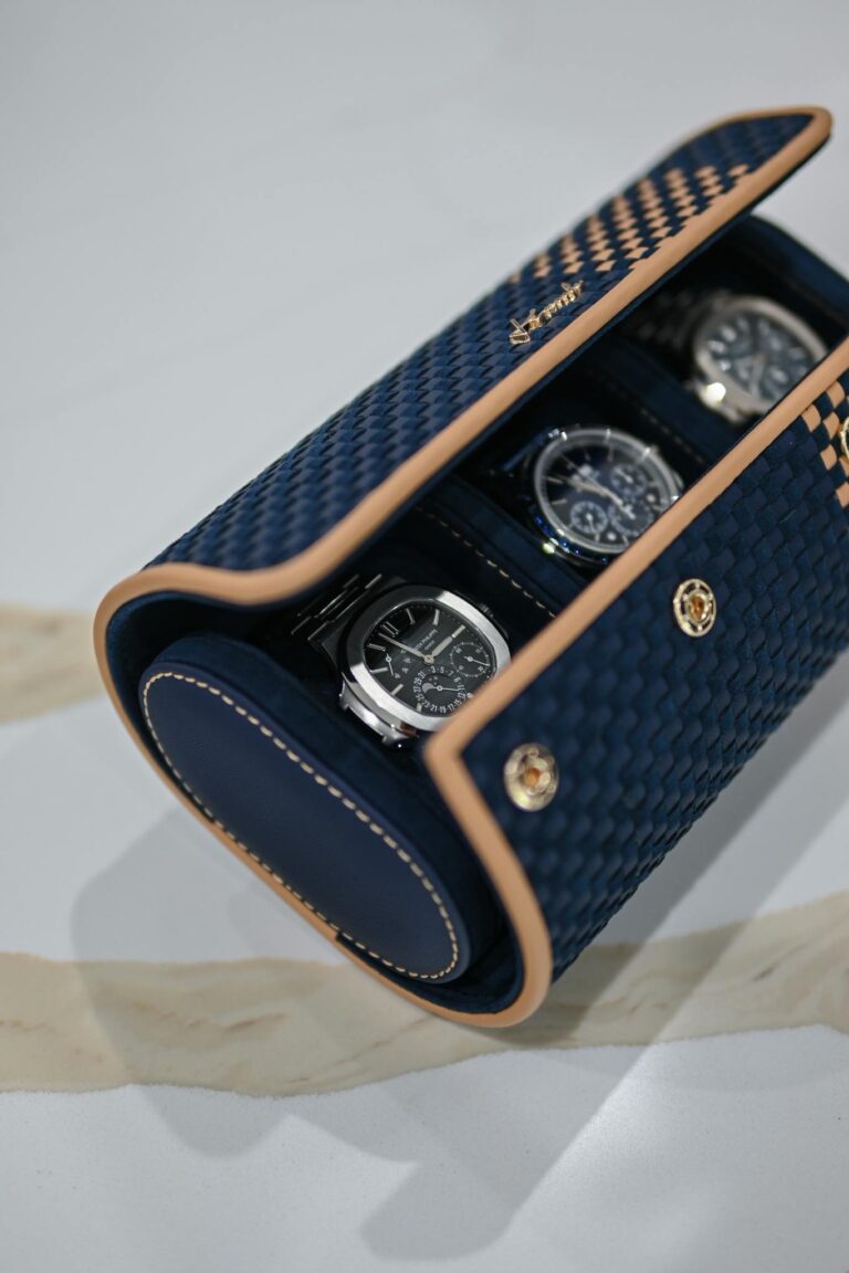 A watch case with three watches in it