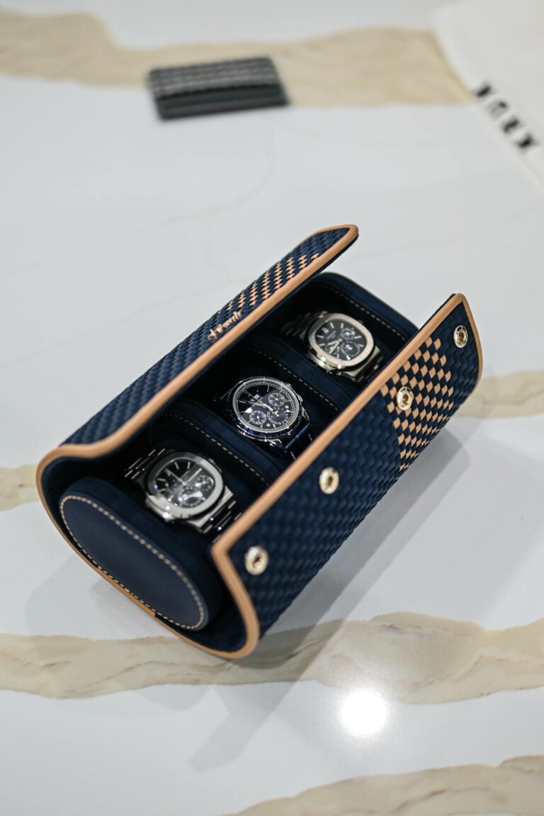 A watch case with three watches in it